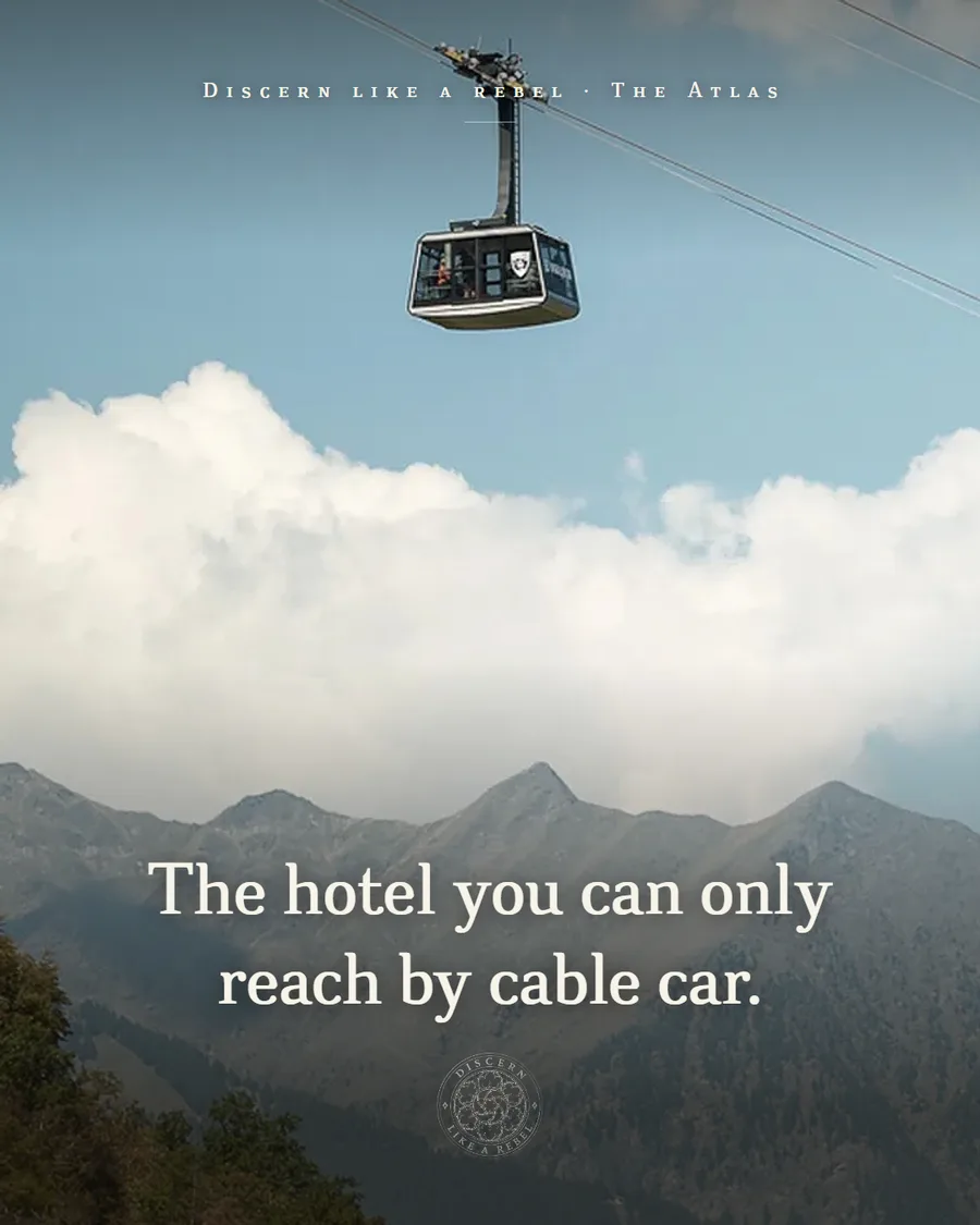 Vigilius cable car above the mountains with the words The hotel you can only reach by cable car