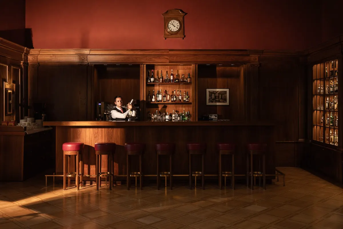The wood-panelled bar at Waldhaus Sils, with its clock above the counter